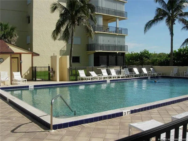 a view of swimming pool with chairs