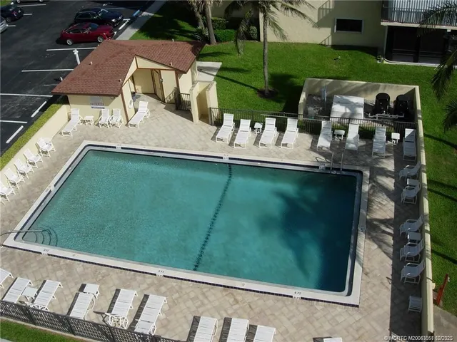 a view of yard from deck with patio
