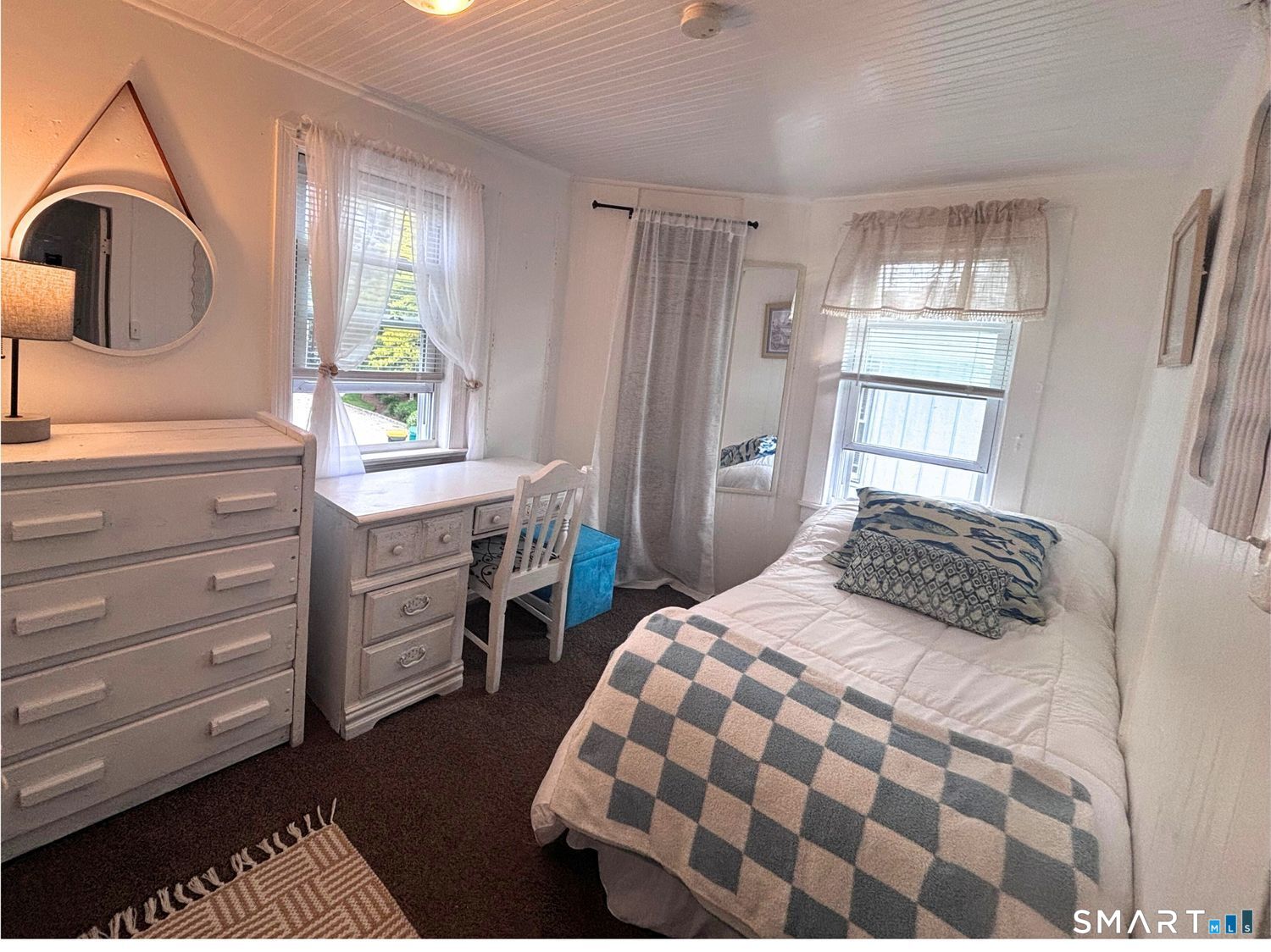 918 Fairfield Beach Road Fairfield, CT 06824 - Photo 3 of 10 a bedroom with a bed next to a window with dresser