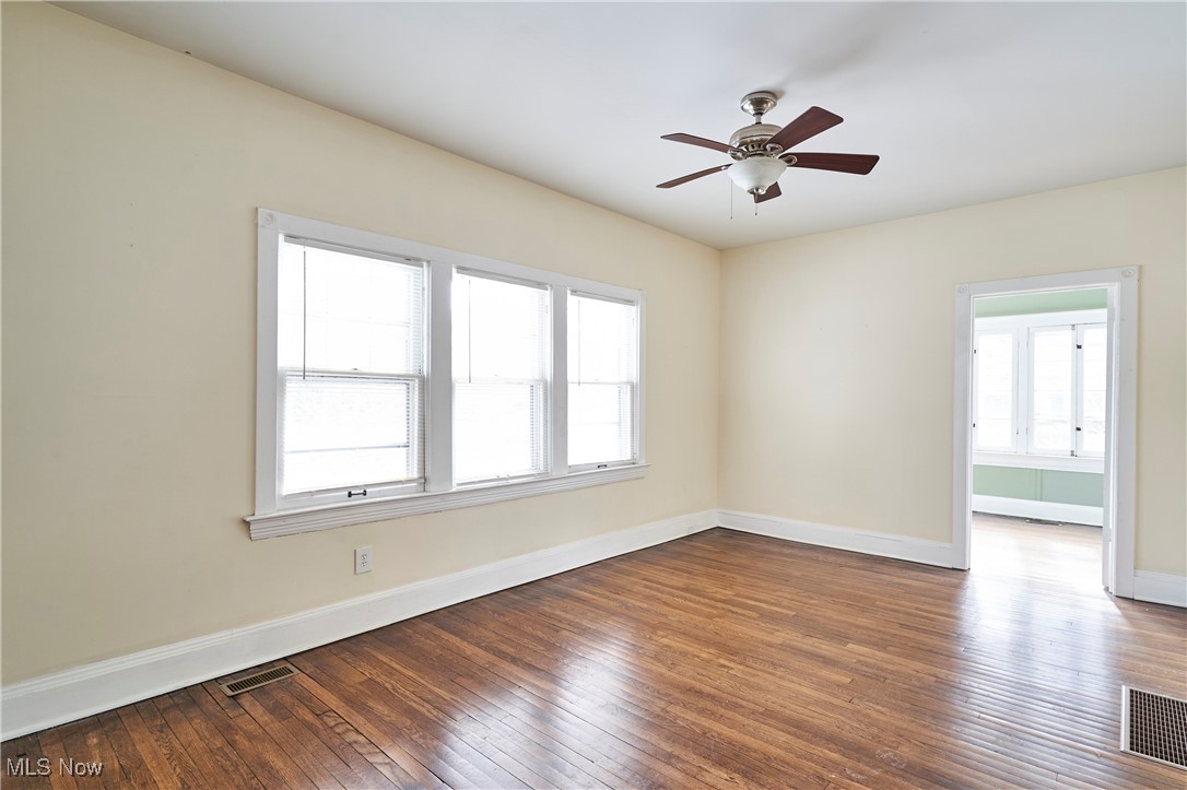 2152 Middlefield Road Cleveland, OH 44106 - Photo 8 of 50 Unfurnished room with wood-type flooring and ceiling fan