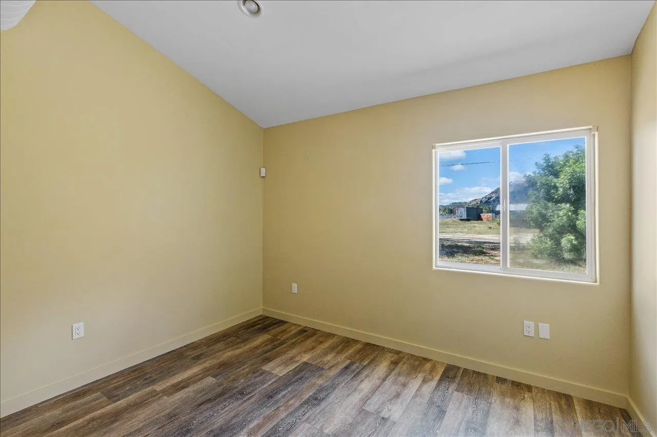 5461 Rainbow Creek Road, Unit THREE LEGAL LOTS Fallbrook, CA 92028 - Photo 25 of 28 a view of an empty room with wooden floor and a window