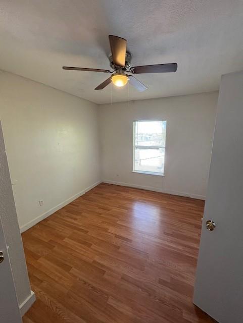709 Grape Street, Unit D Abilene, TX 79601 - Photo 6 of 7 wooden floor in an empty room with a window