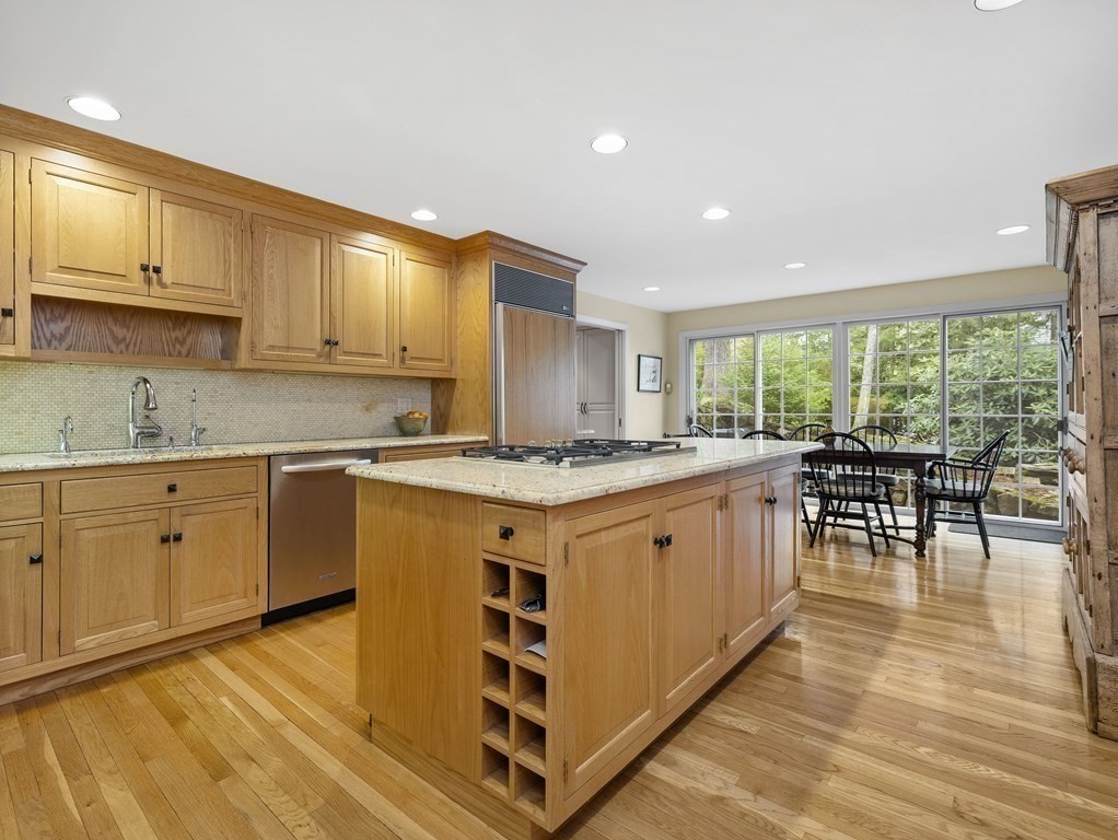 177 Hampshire Road Wellesley, MA 02481 - Photo 6 of 15 a kitchen with granite countertop a stove a sink a dining table and chairs
