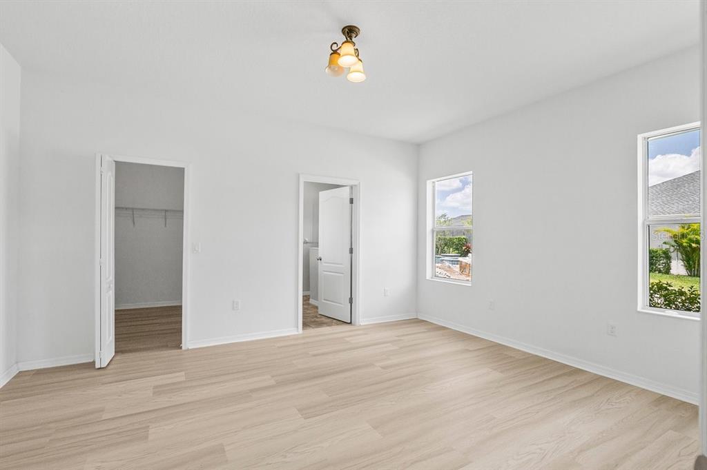 11790 Fennemore Way Parrish, FL 34219 - Photo 12 of 41 a view of an empty room with window and wooden floor