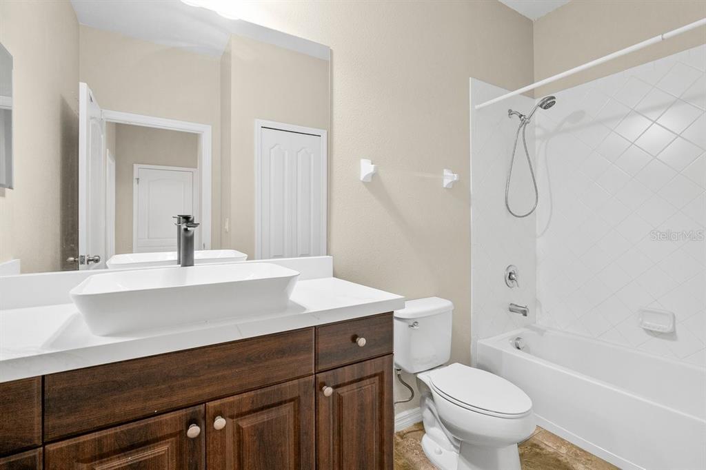 11790 Fennemore Way Parrish, FL 34219 - Photo 20 of 41 a bathroom with a sink toilet vanity and shower