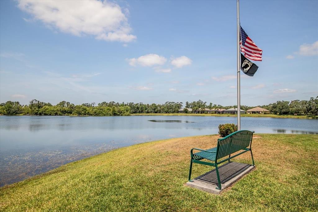 11790 Fennemore Way Parrish, FL 34219 - Photo 32 of 41 a swimming pool with outdoor seating and lake