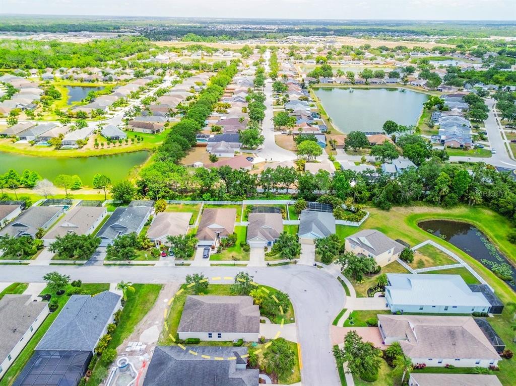 11790 Fennemore Way Parrish, FL 34219 - Photo 40 of 41 an aerial view of residential houses with outdoor space and swimming pool