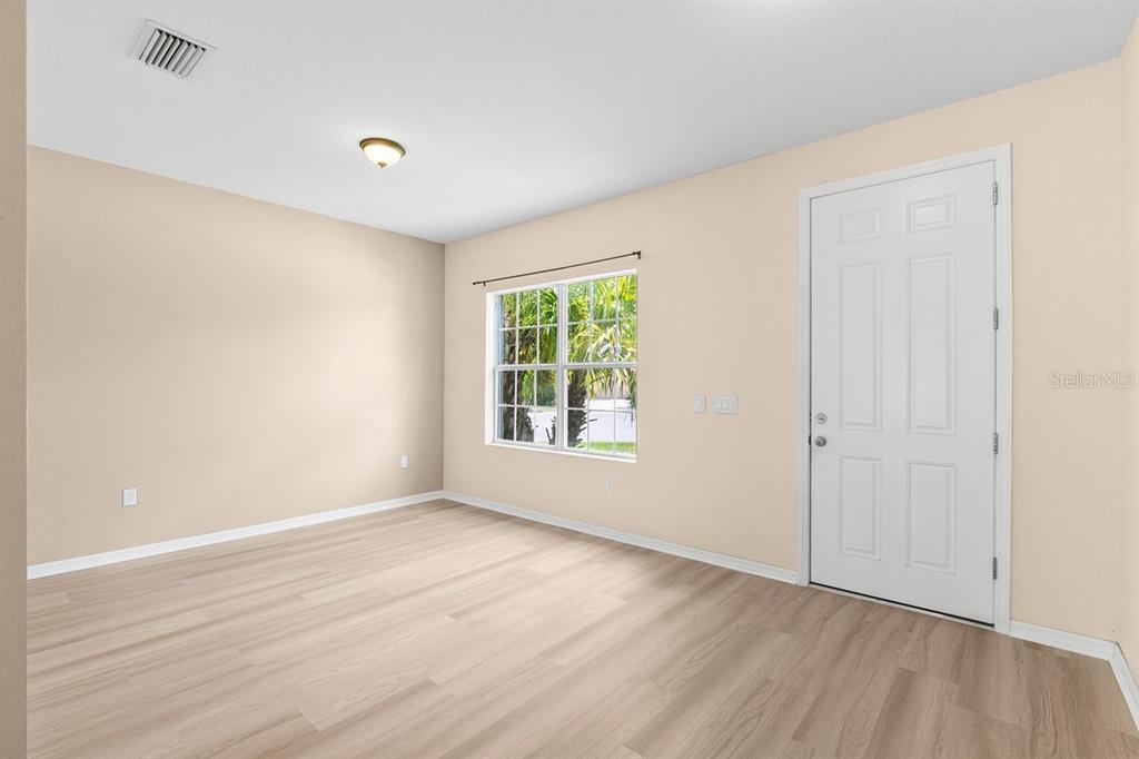 11790 Fennemore Way Parrish, FL 34219 - Photo 5 of 41 a view of an empty room with wooden floor and a window