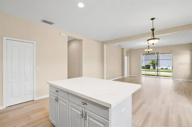 a view of an empty room and wooden floor