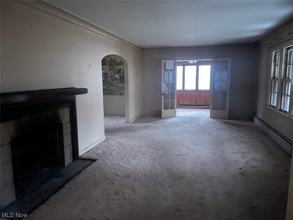 3085 Albion Road Cleveland, OH 44120 - Photo 7 of 32 Unfurnished living room featuring a baseboard radiator and dark colored carpet
