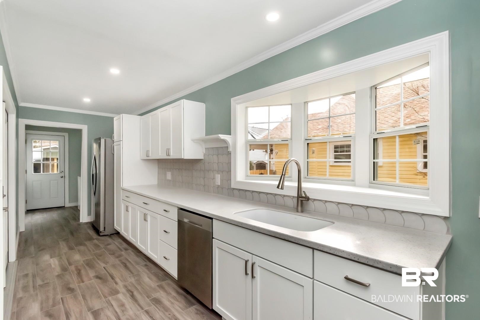 2157 Homewood Street Mobile, AL 36606 - Photo 10 of 36 Kitchen featuring crown molding, stainless steel appliances, a sink, and decorative backsplash