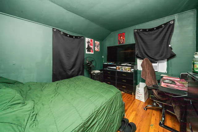 a bedroom with a bed and a flat screen tv