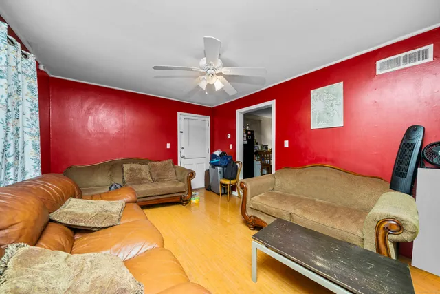 a living room with furniture and a ceiling fan