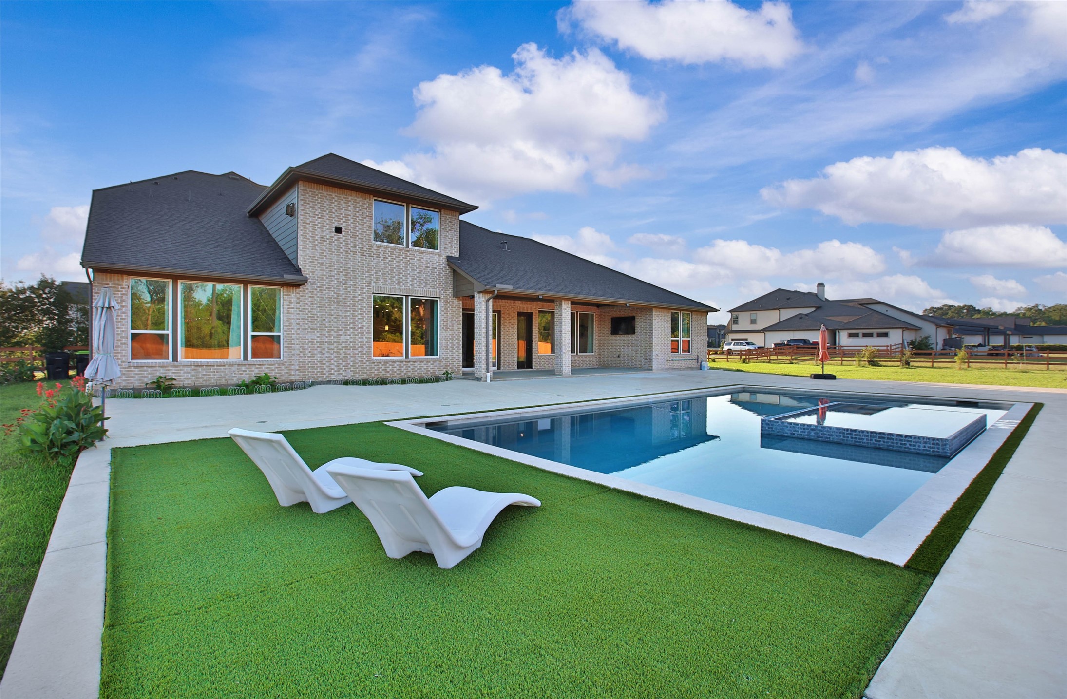 29402 Cir S Rnch Trail Fulshear, TX 77406 - Photo 42 of 50 This lounge area by the pool is a great spot to catch some rays and relax in the sun.