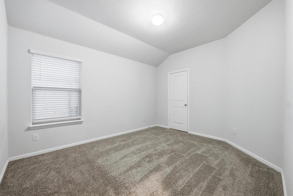 9308 Desertrock Road Fort Worth, TX 76131 - Photo 21 of 29 an empty room with windows
