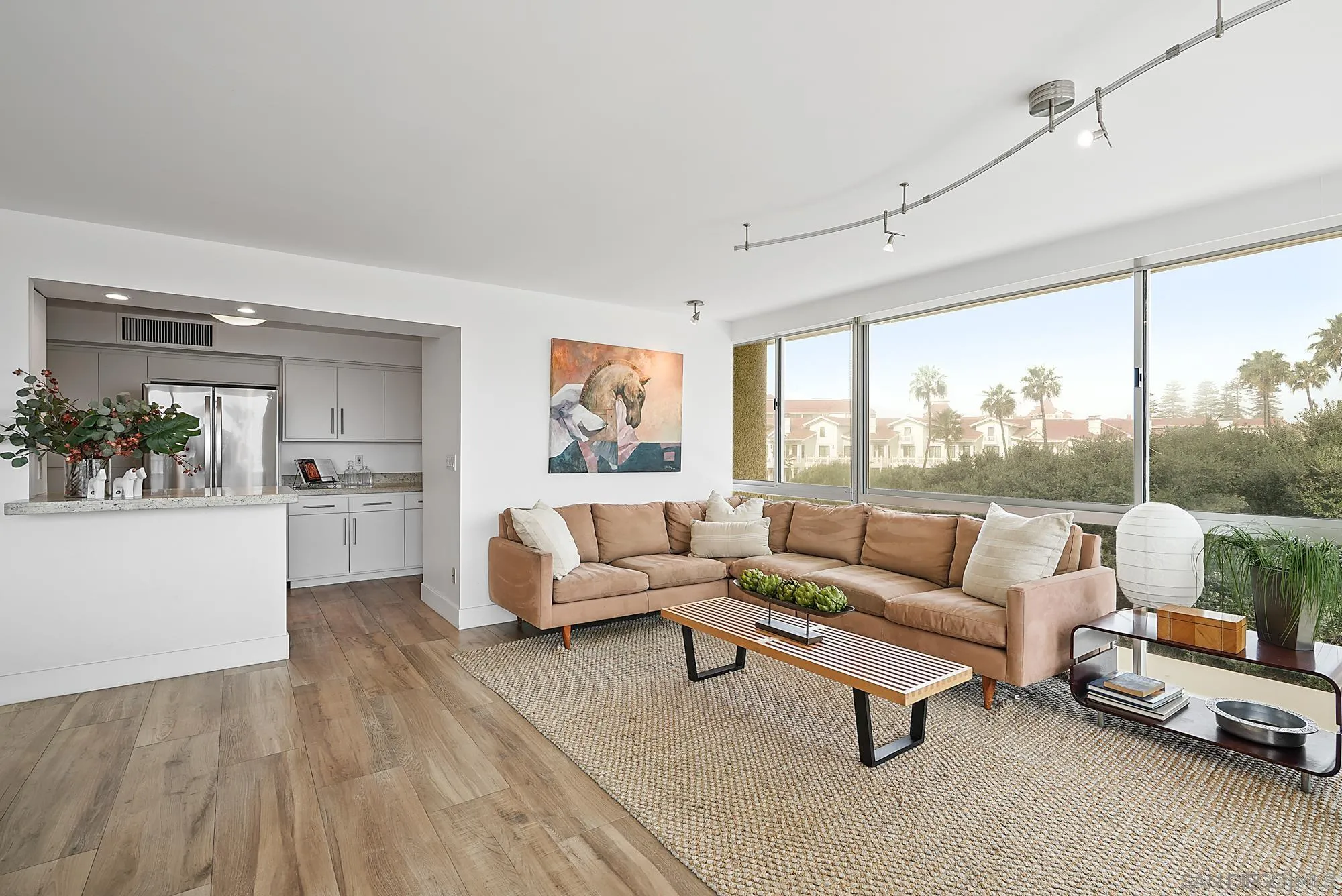1720 Avenida Del Mundo, Unit 208 Coronado, CA 92118 - Photo 11 of 42 a living room with furniture and a large window