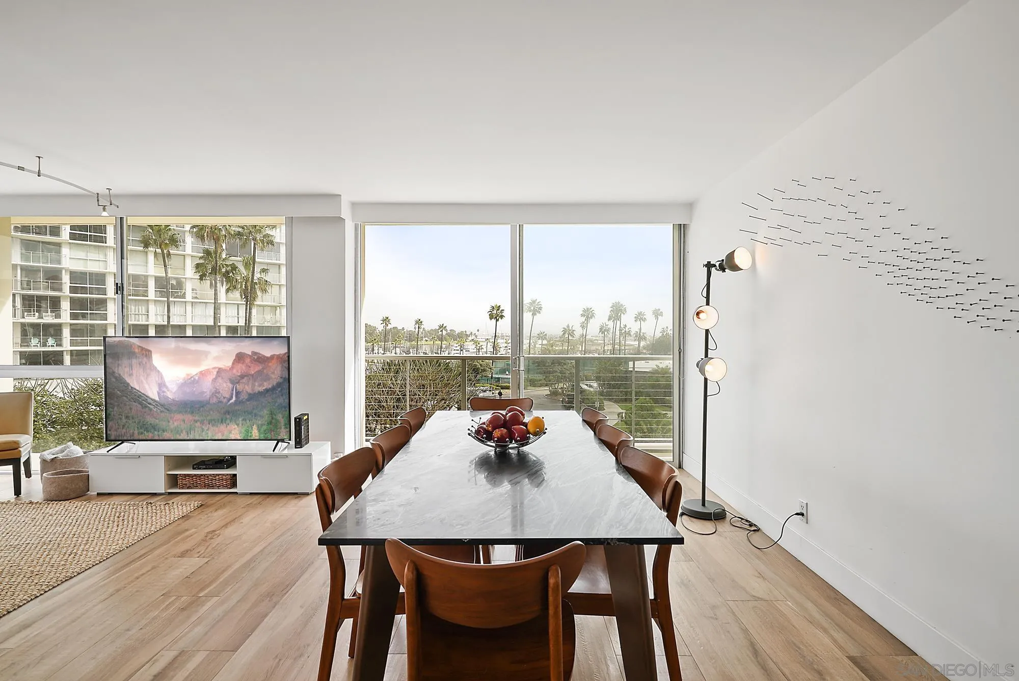 1720 Avenida Del Mundo, Unit 208 Coronado, CA 92118 - Photo 12 of 42 a dining room with furniture a window and a flat screen tv