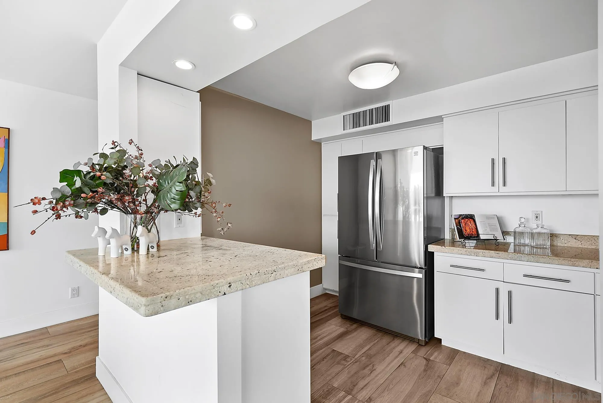 1720 Avenida Del Mundo, Unit 208 Coronado, CA 92118 - Photo 15 of 42 a kitchen with stainless steel appliances granite countertop a refrigerator cabinets and wooden floor