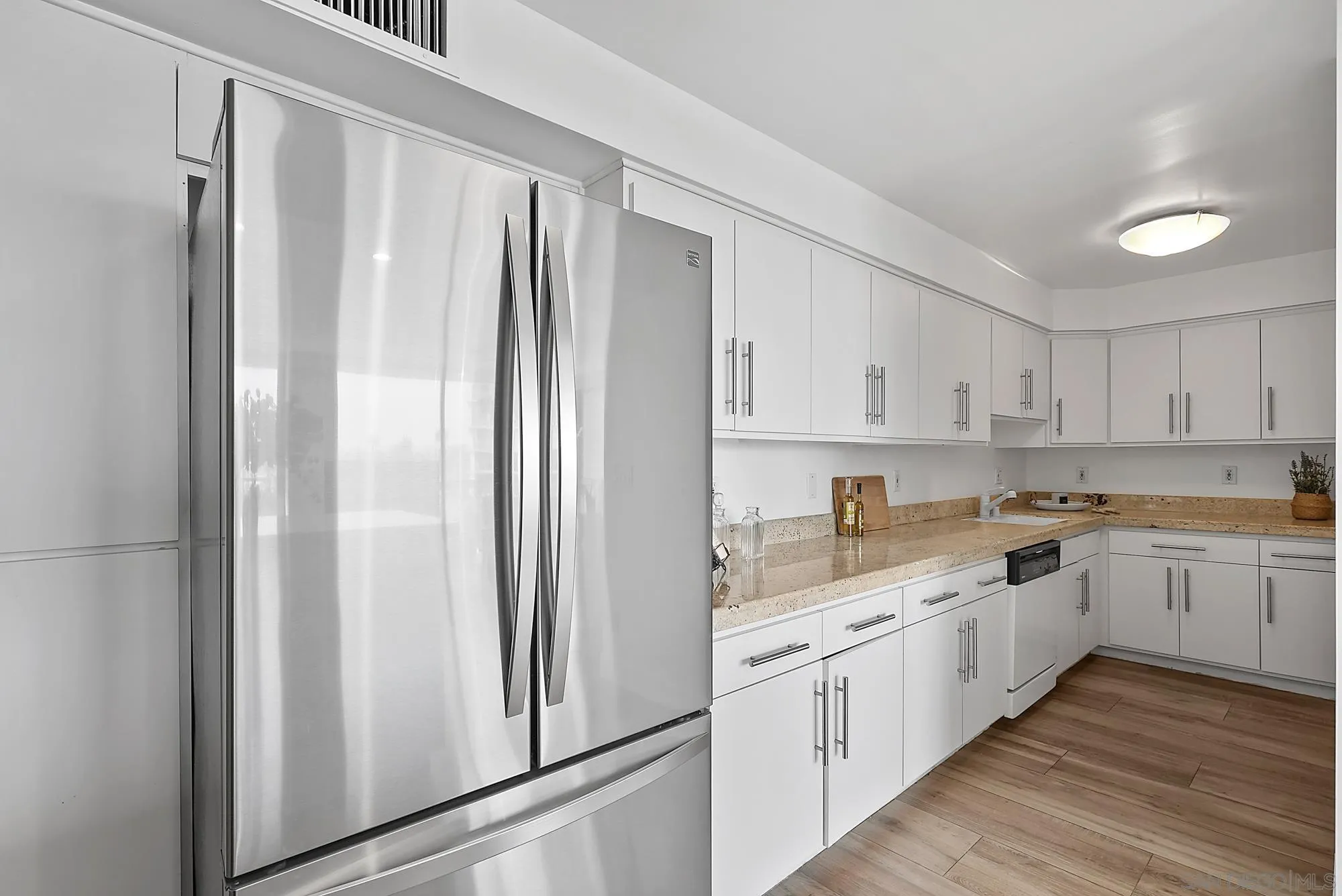 1720 Avenida Del Mundo, Unit 208 Coronado, CA 92118 - Photo 16 of 42 a kitchen with white cabinets and white appliances
