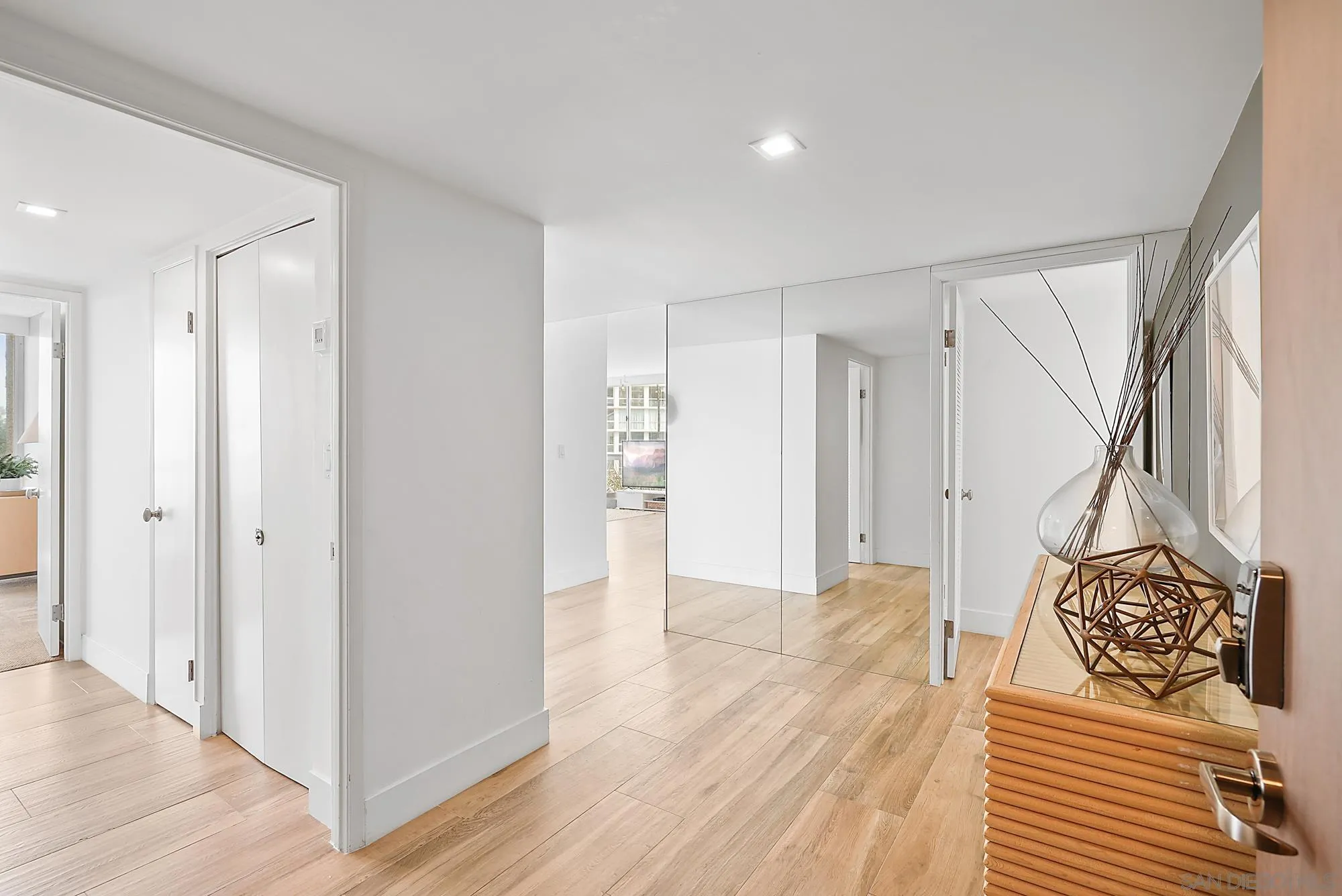 1720 Avenida Del Mundo, Unit 208 Coronado, CA 92118 - Photo 20 of 42 a view of a hallway with wooden floor and a bathroom