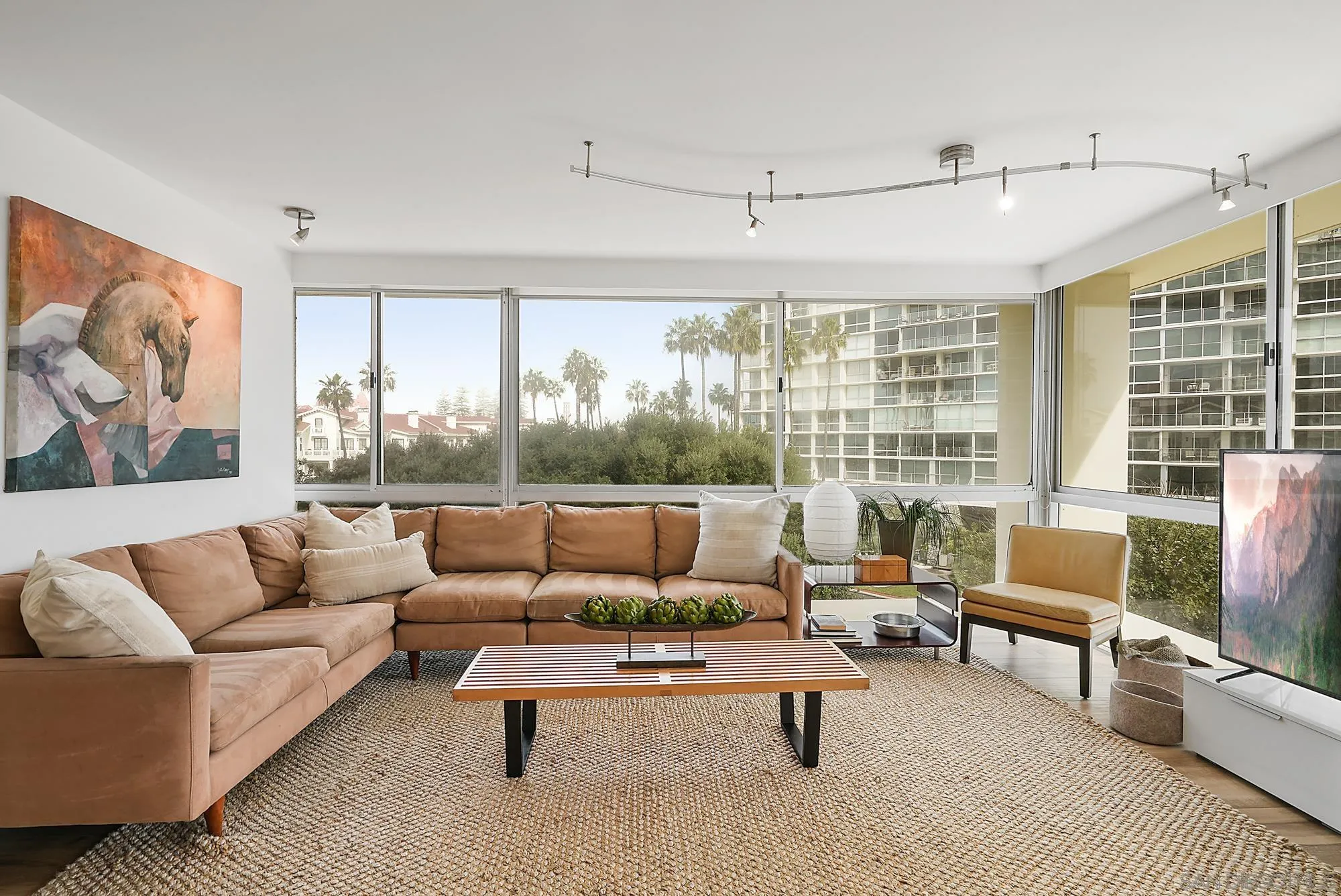 1720 Avenida Del Mundo, Unit 208 Coronado, CA 92118 - Photo 2 of 42 a living room with furniture and a large window