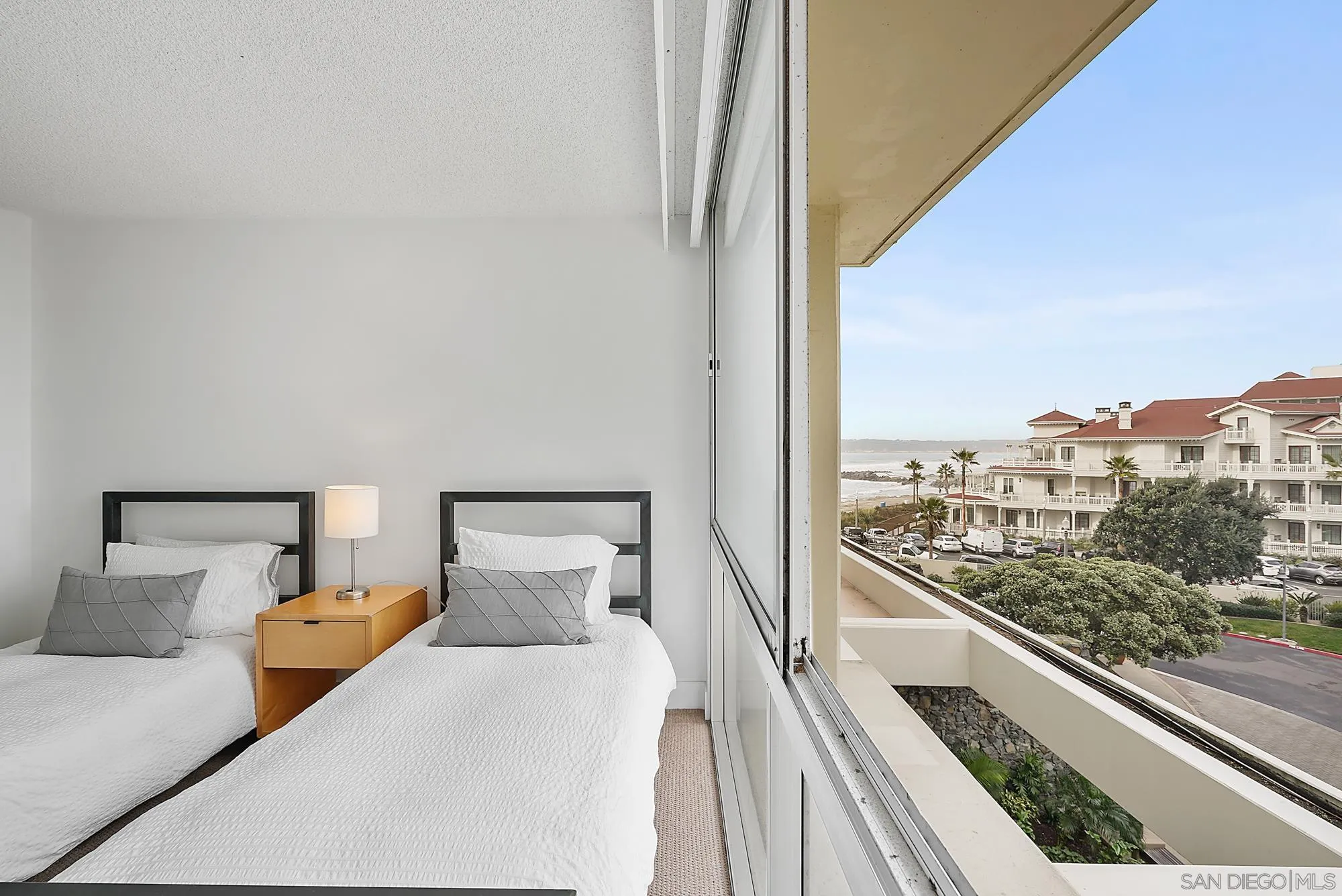 1720 Avenida Del Mundo, Unit 208 Coronado, CA 92118 - Photo 22 of 42 a bed room with a bed