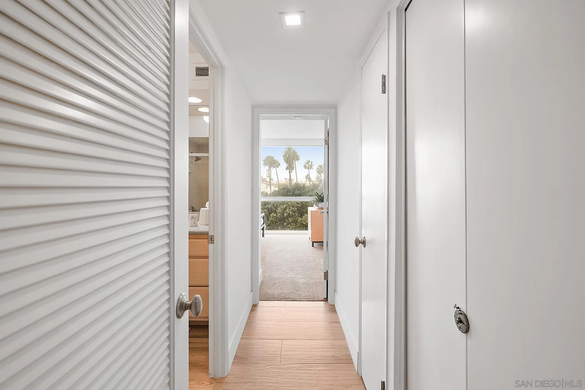 1720 Avenida Del Mundo, Unit 208 Coronado, CA 92118 - Photo 23 of 42 a view of a hallway with wooden floor