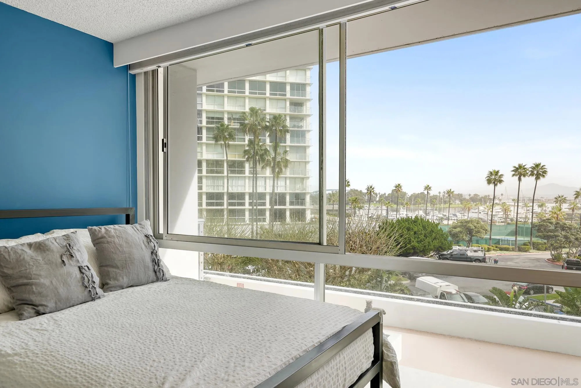 1720 Avenida Del Mundo, Unit 208 Coronado, CA 92118 - Photo 28 of 42 a living room with a couch and a large window