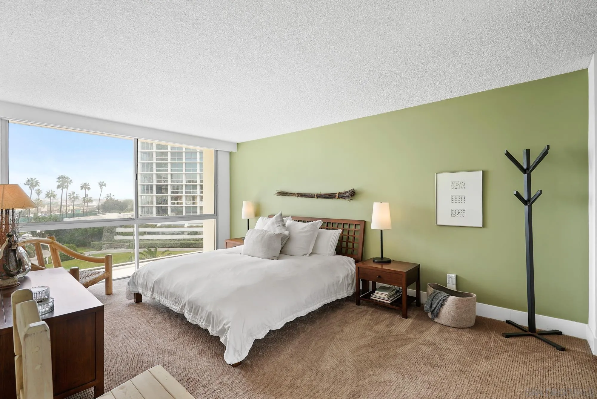 1720 Avenida Del Mundo, Unit 208 Coronado, CA 92118 - Photo 29 of 42 a bedroom with a bed and a table