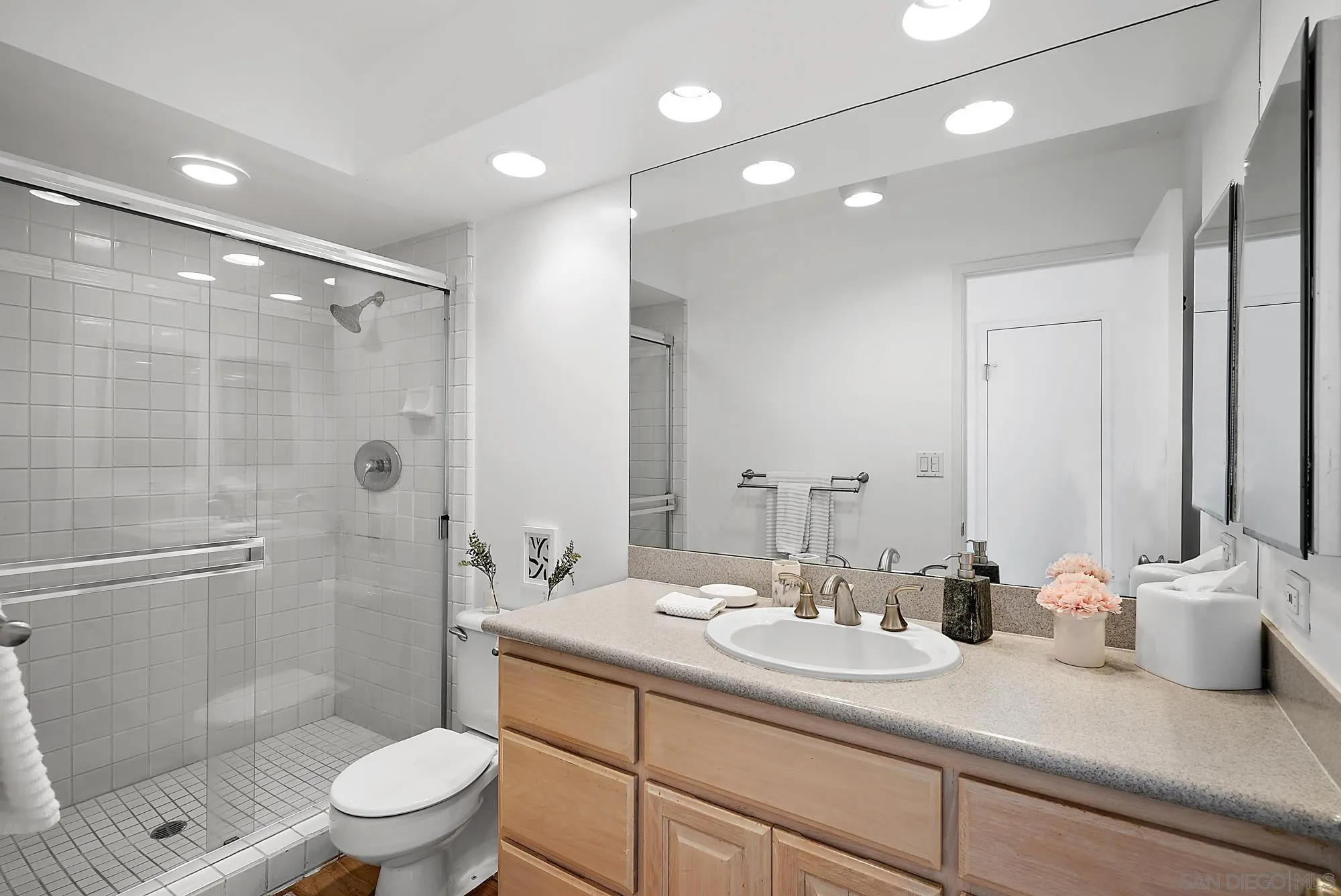 1720 Avenida Del Mundo, Unit 208 Coronado, CA 92118 - Photo 32 of 42 a bathroom with a sink a toilet and shower