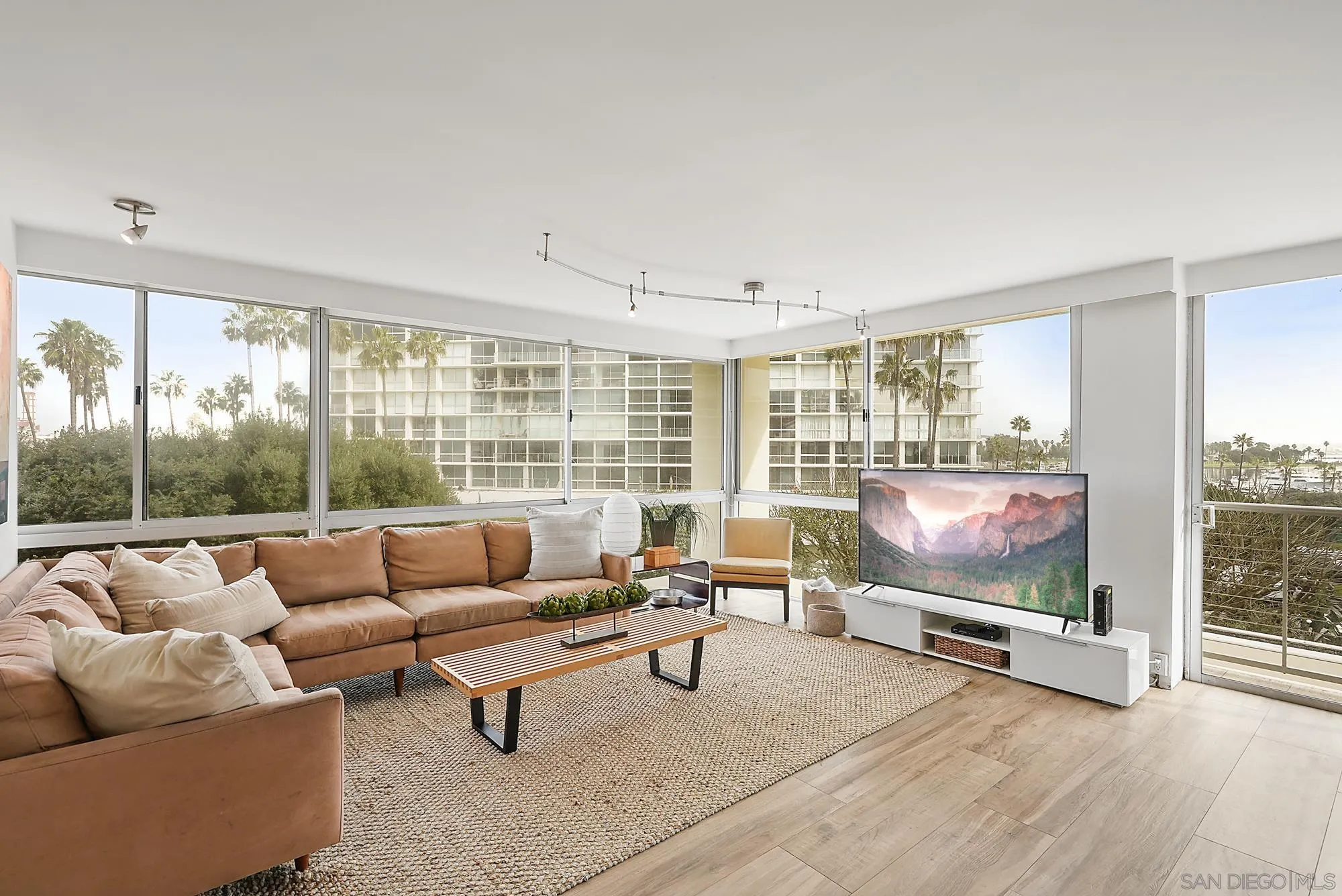 1720 Avenida Del Mundo, Unit 208 Coronado, CA 92118 - Photo 5 of 42 a living room with furniture and a flat screen tv