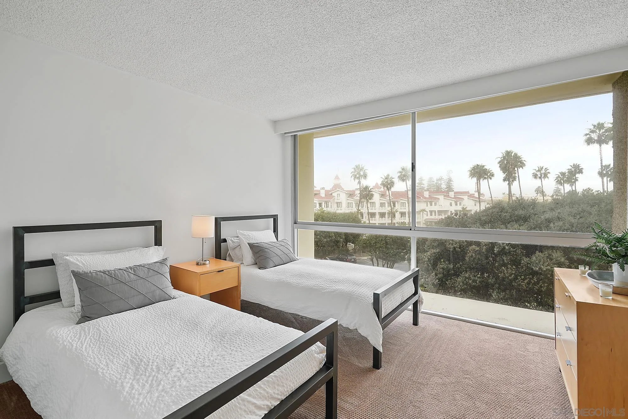 1720 Avenida Del Mundo, Unit 208 Coronado, CA 92118 - Photo 6 of 42 a living room with furniture and a large window
