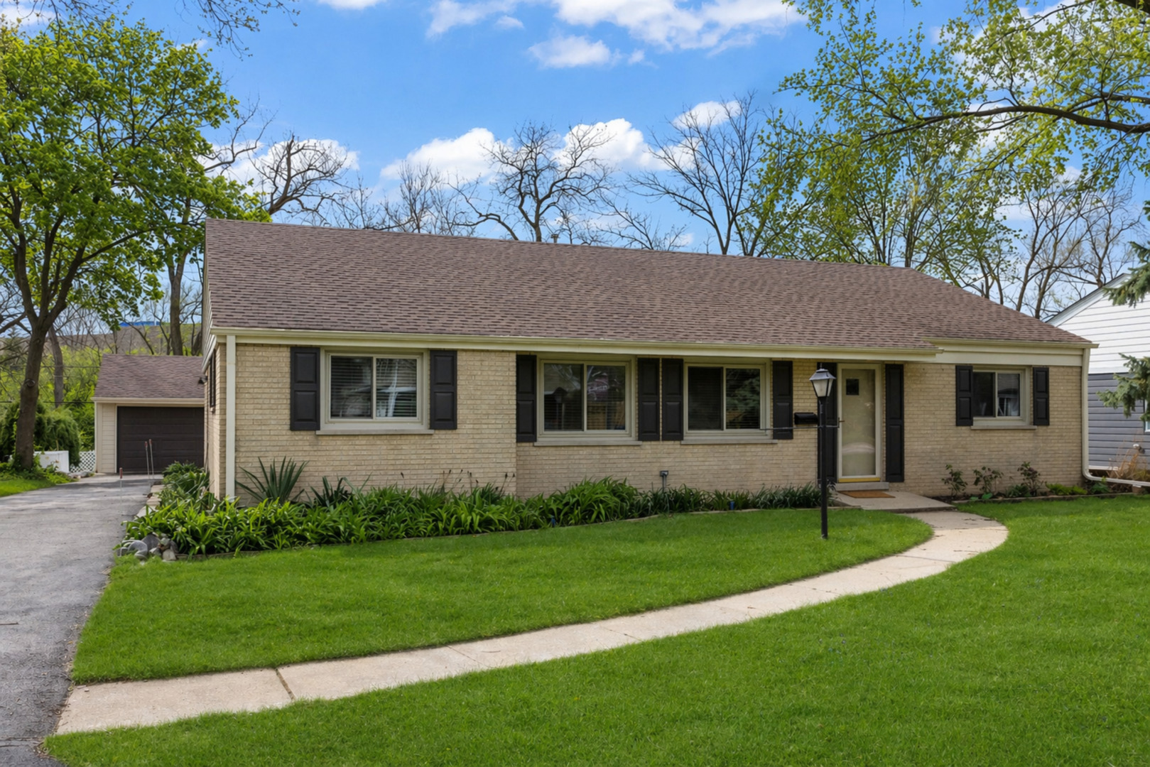 a front view of a house with a garden