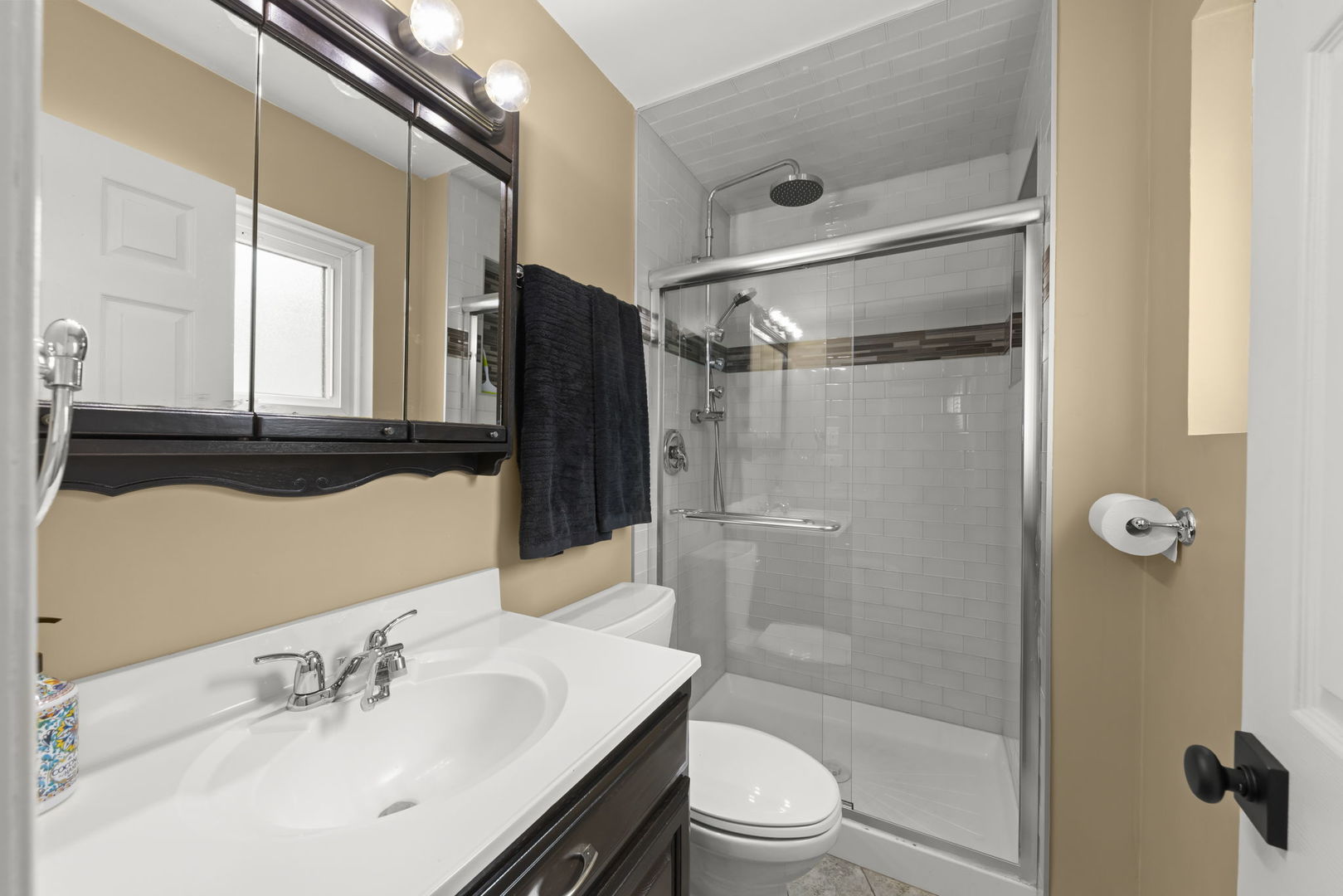 5818 Ridgewood Drive Western Springs, IL 60558 - Photo 13 of 25 a bathroom with a sink mirror toilet and shower