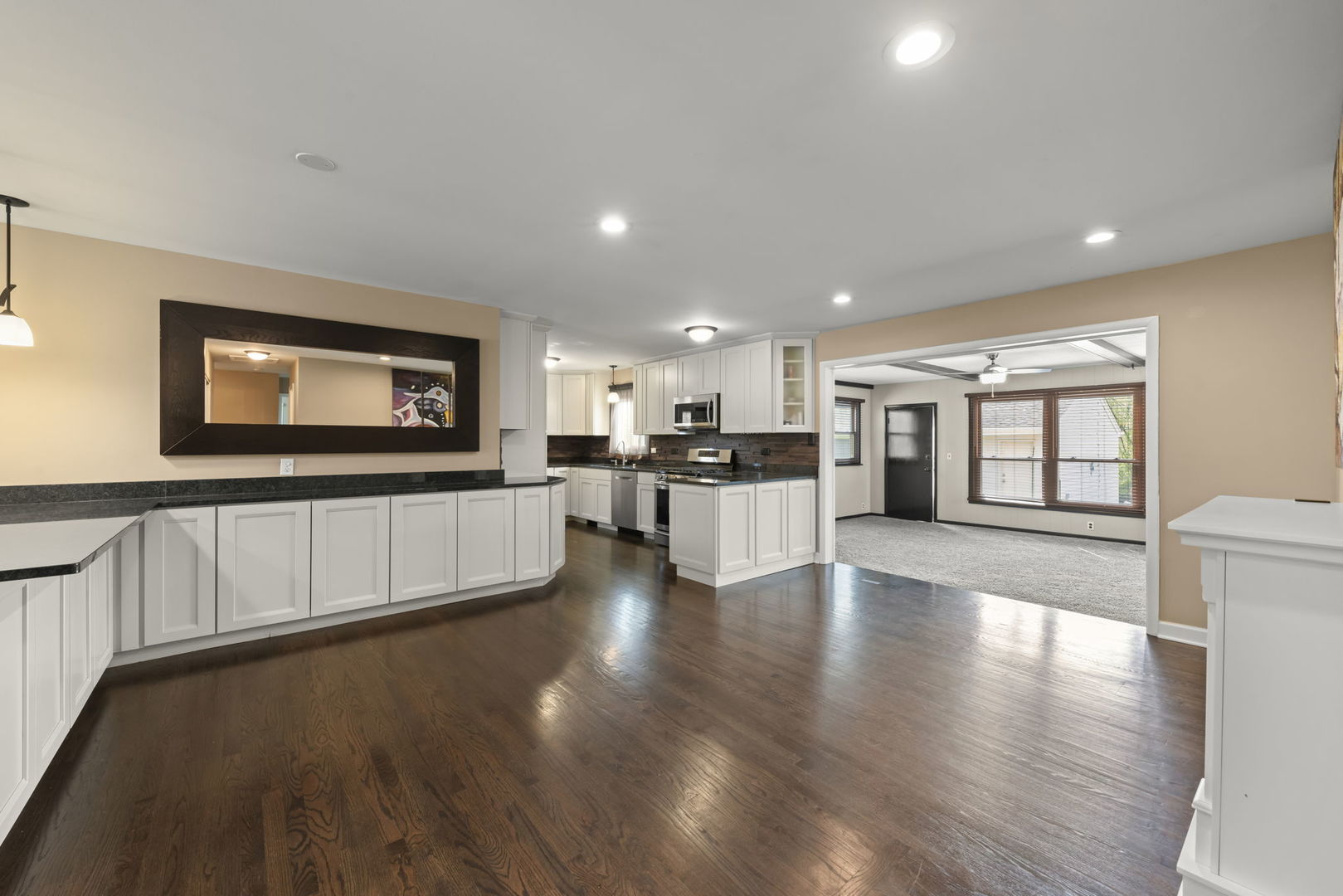 5818 Ridgewood Drive Western Springs, IL 60558 - Photo 5 of 25 a living room with stainless steel appliances kitchen island granite countertop a stove a sink a refrigerator white cabinets and wooden floor