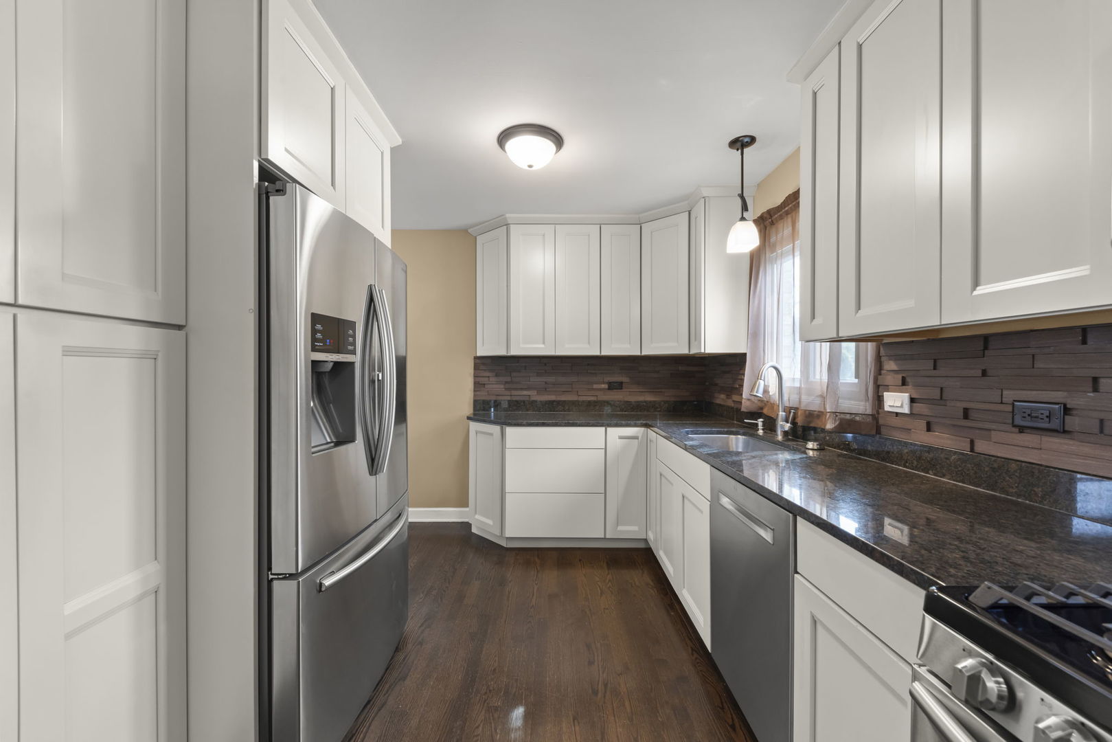 5818 Ridgewood Drive Western Springs, IL 60558 - Photo 9 of 25 a kitchen with stainless steel appliances granite countertop a refrigerator and a stove