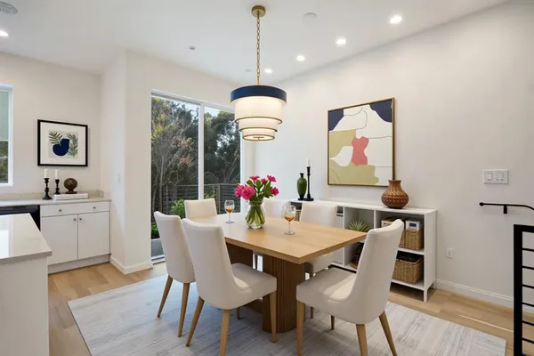 a view of a dining room with furniture window and wooden floor