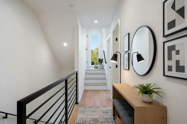 a bedroom with a white bed and white cabinets