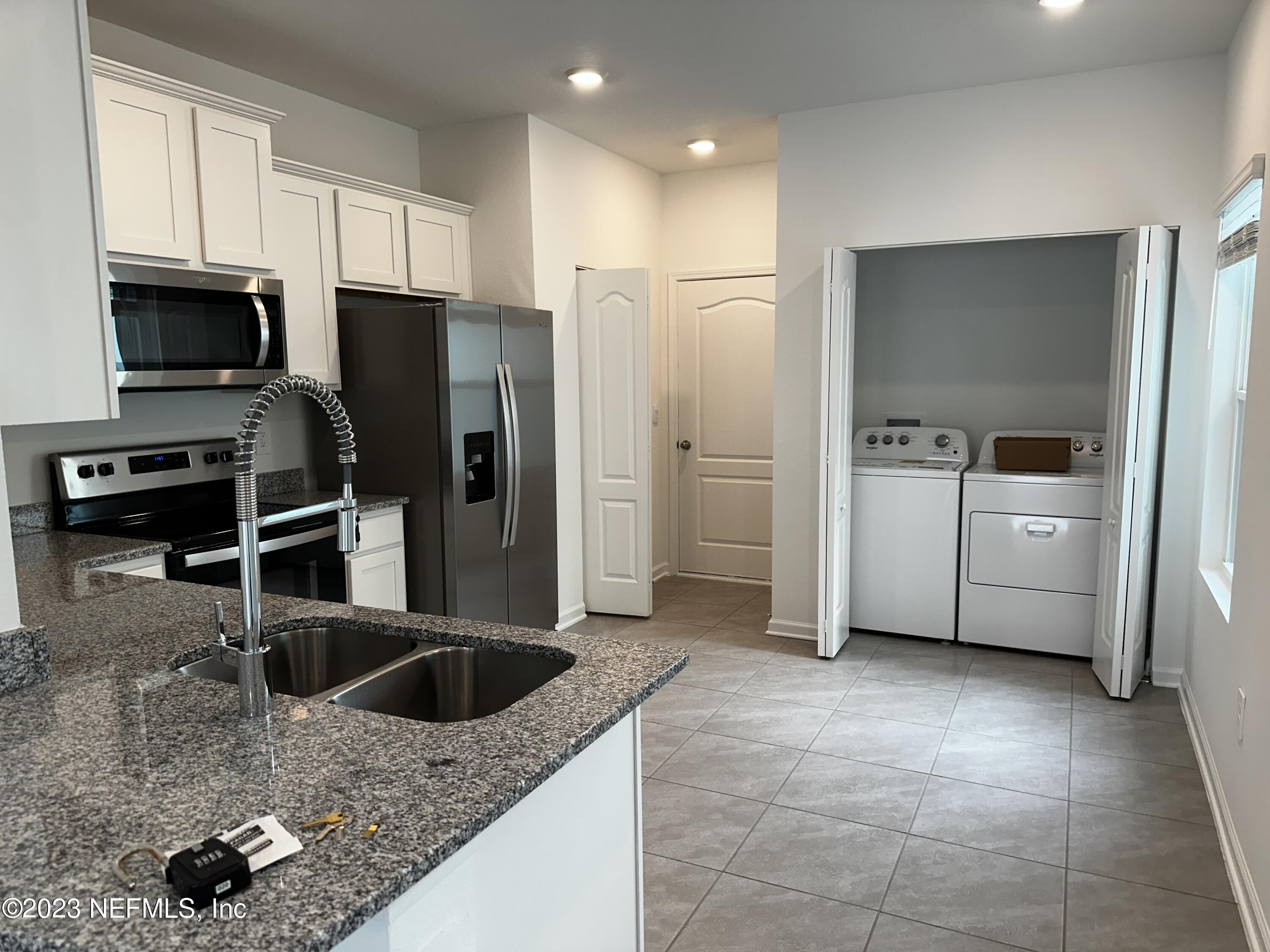 409 Talulla Trail St. Augustine, FL 32095 - Photo 25 of 58 a kitchen with stainless steel appliances granite countertop a sink a stove and a refrigerator