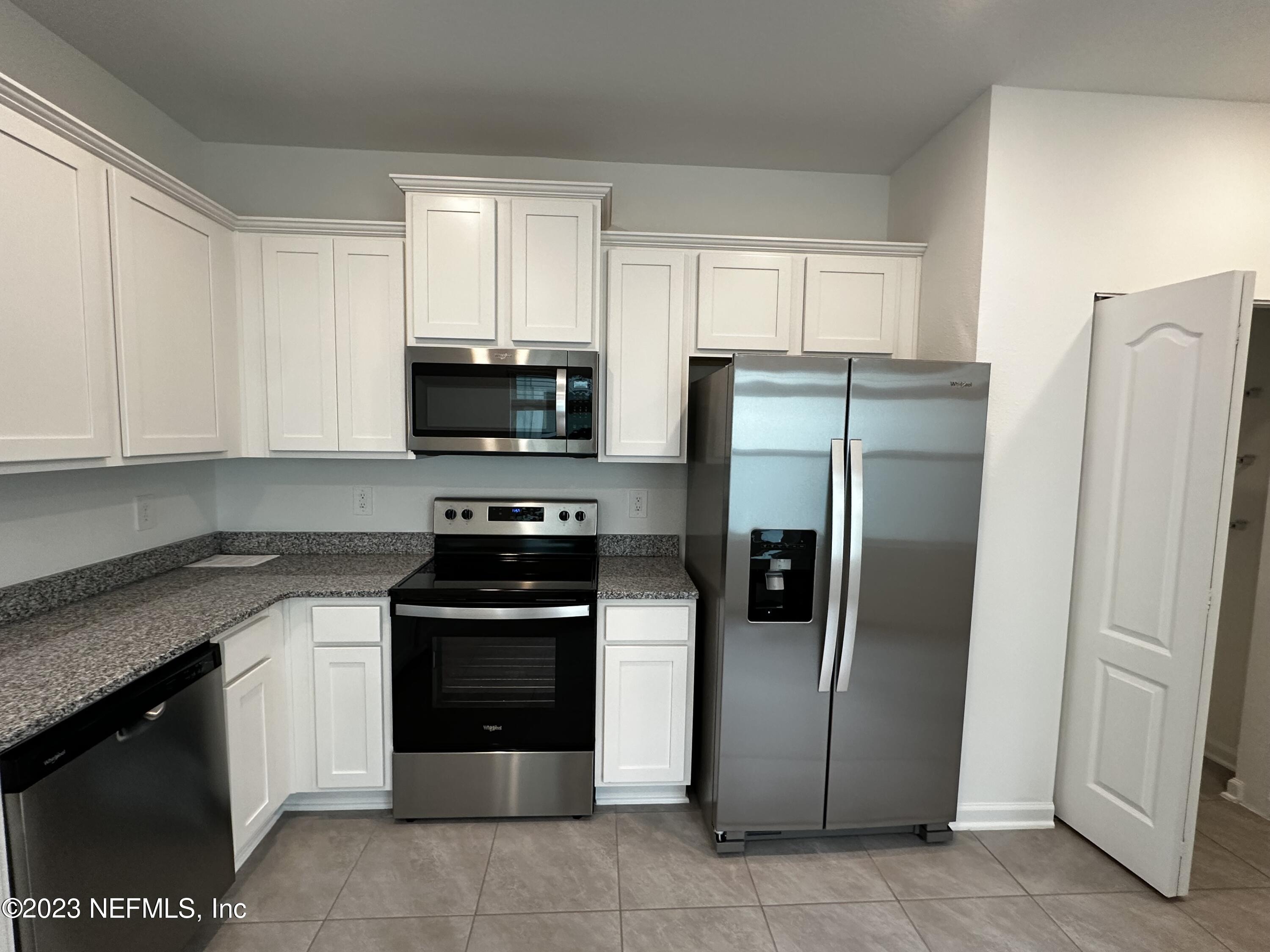 409 Talulla Trail St. Augustine, FL 32095 - Photo 28 of 58 a kitchen with stainless steel appliances granite countertop a refrigerator and a stove