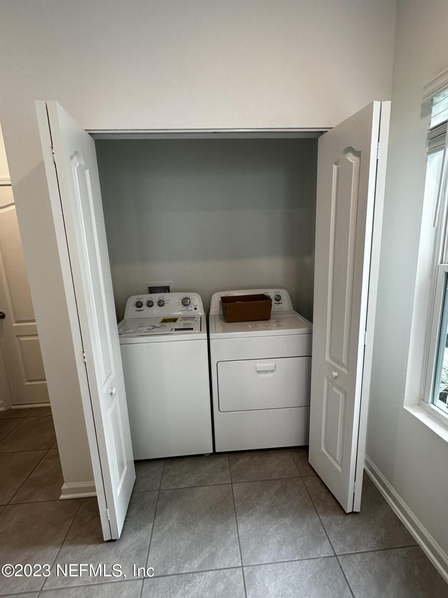 409 Talulla Trail St. Augustine, FL 32095 - Photo 29 of 58 a utility room with cabinets washer and dryer
