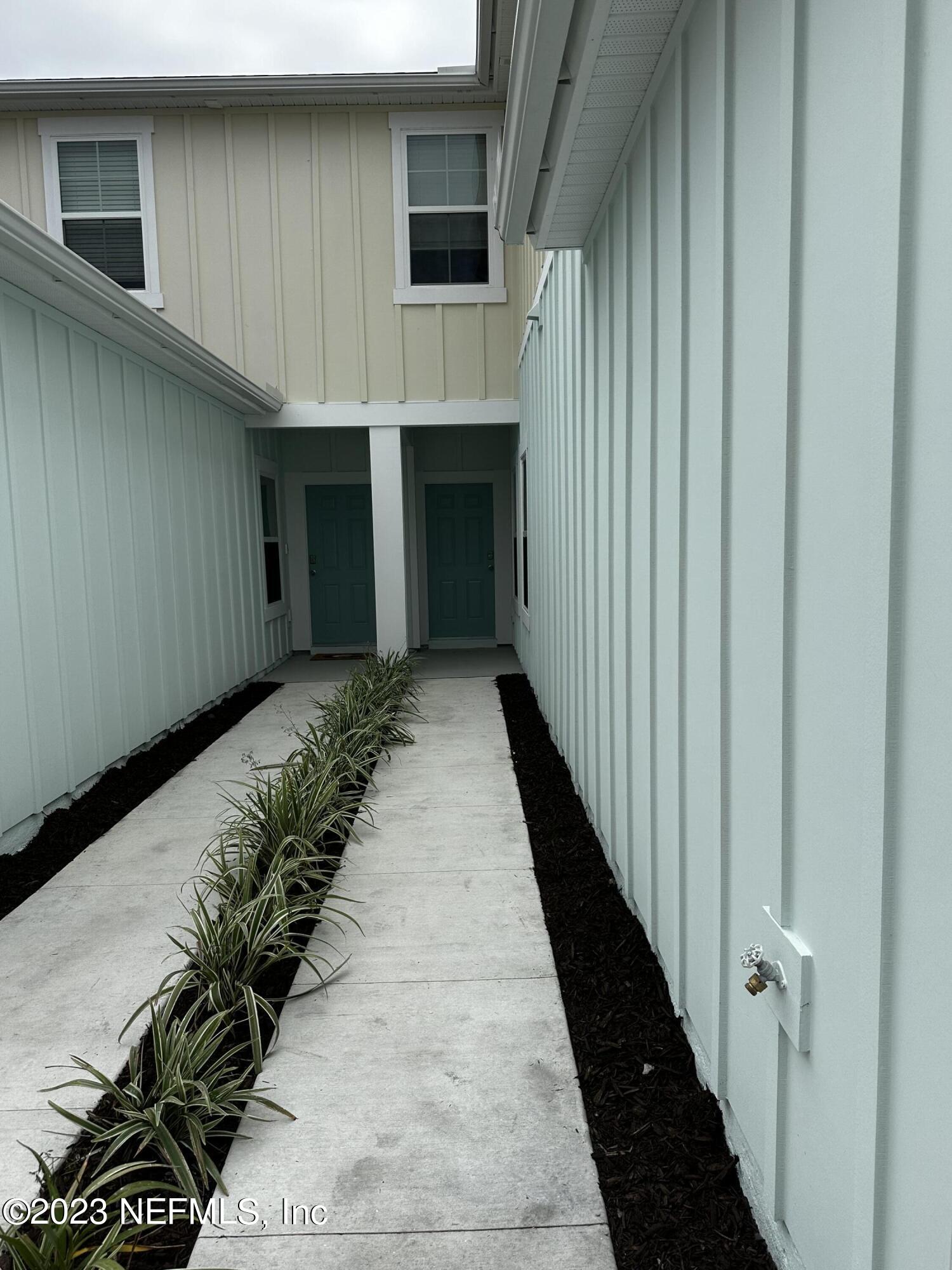 409 Talulla Trail St. Augustine, FL 32095 - Photo 3 of 58 a view of a house with wooden walls