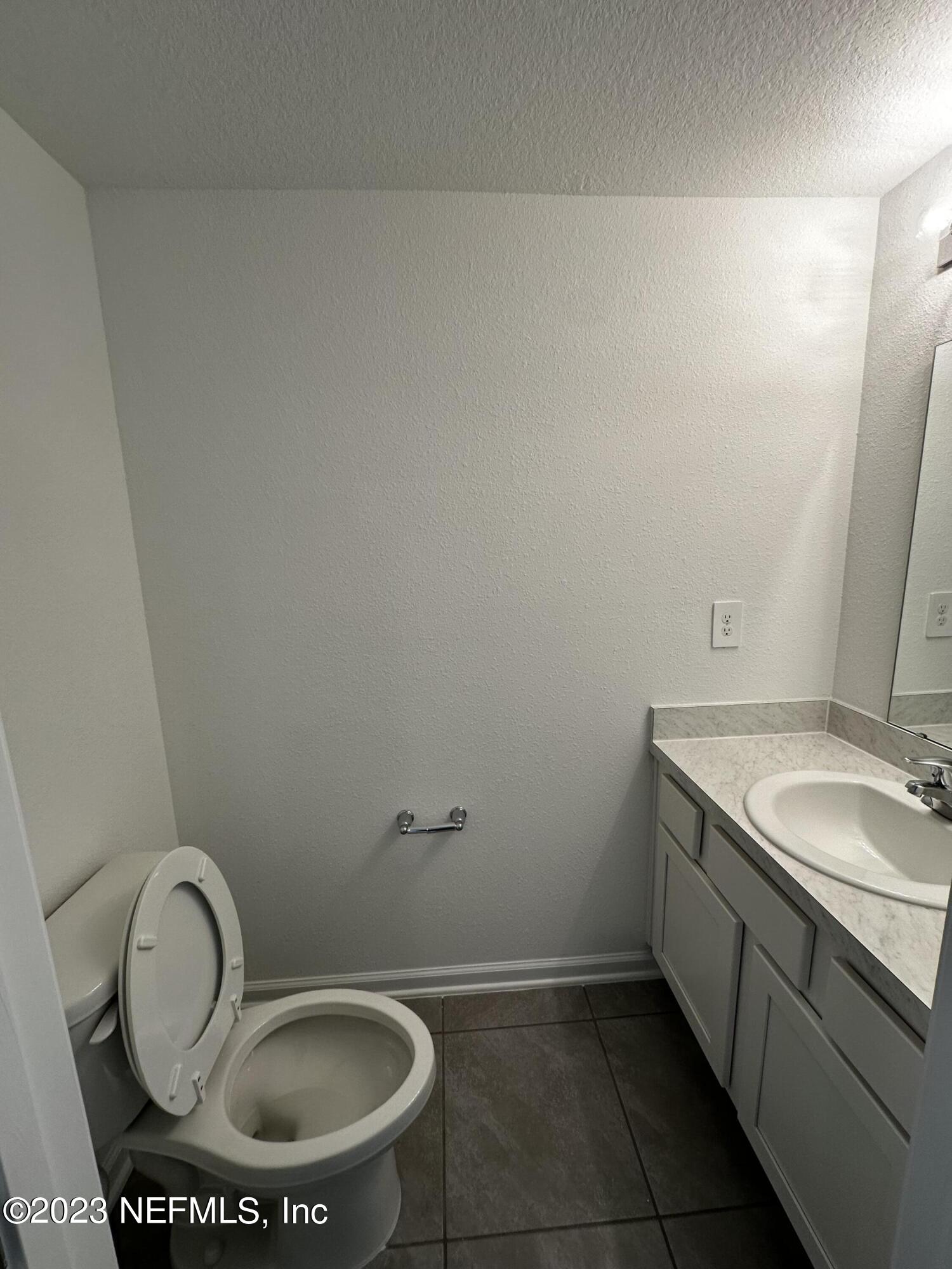 409 Talulla Trail St. Augustine, FL 32095 - Photo 35 of 58 a bathroom with a granite countertop toilet and a sink