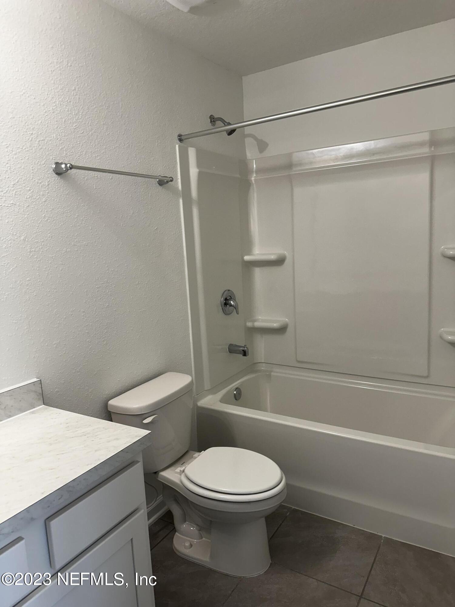 409 Talulla Trail St. Augustine, FL 32095 - Photo 41 of 58 a white toilet and tub next to a bathroom sink