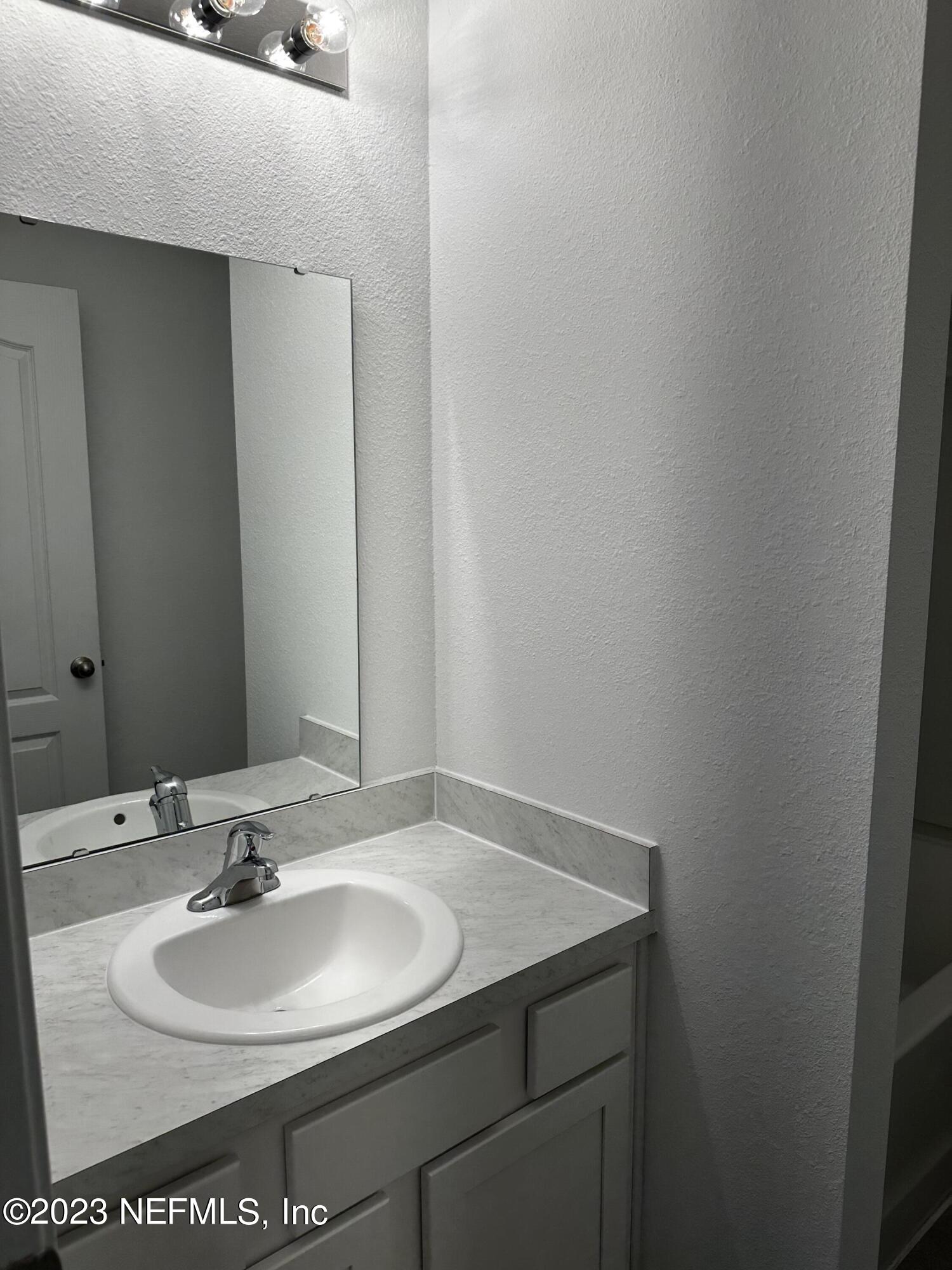 409 Talulla Trail St. Augustine, FL 32095 - Photo 49 of 58 a bathroom with a sink and a mirror