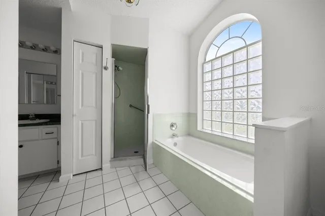 a spacious bathroom with a bathtub and a shower