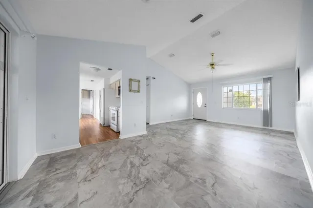 an empty room with a empty space and windows