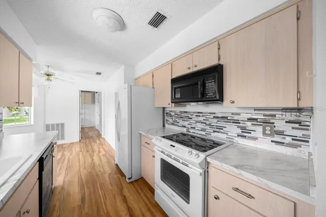 a kitchen with a stove and a microwave