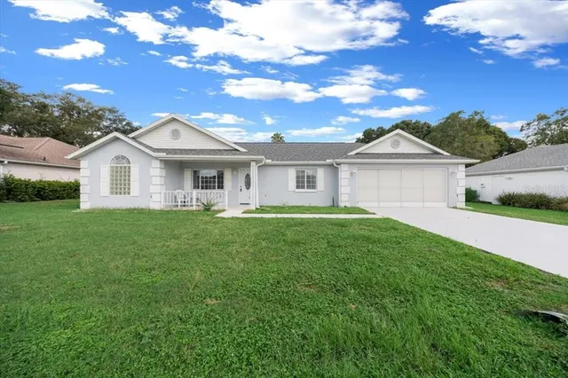 a view of a house with a backyard