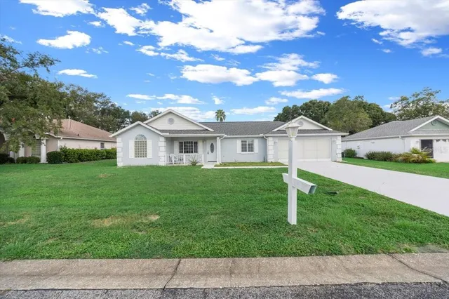 a view of house with a yard